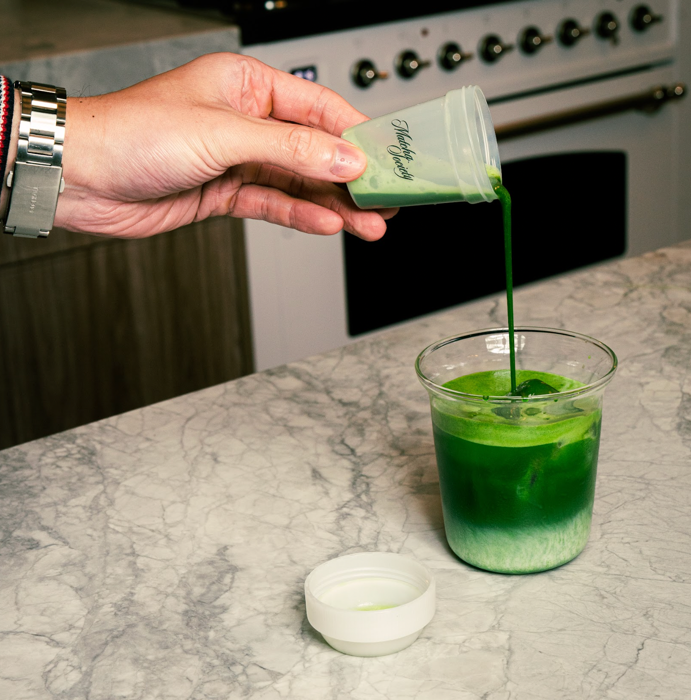 Matcha Society Matcha Mini Shaker Pouring into Milk