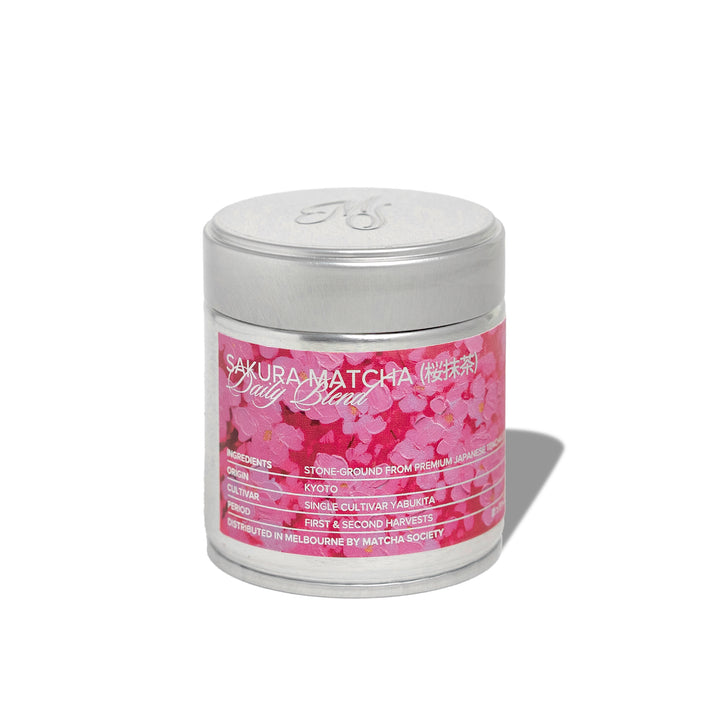 Limited edition Sakura Matcha Daily Blend from Kyoto, shown with cherry blossom flowers and vibrant green matcha powder